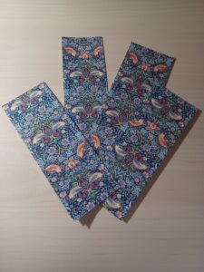 four bookmarks created from the covers of a notebook, all part of William Morris Strawberry Thief design.